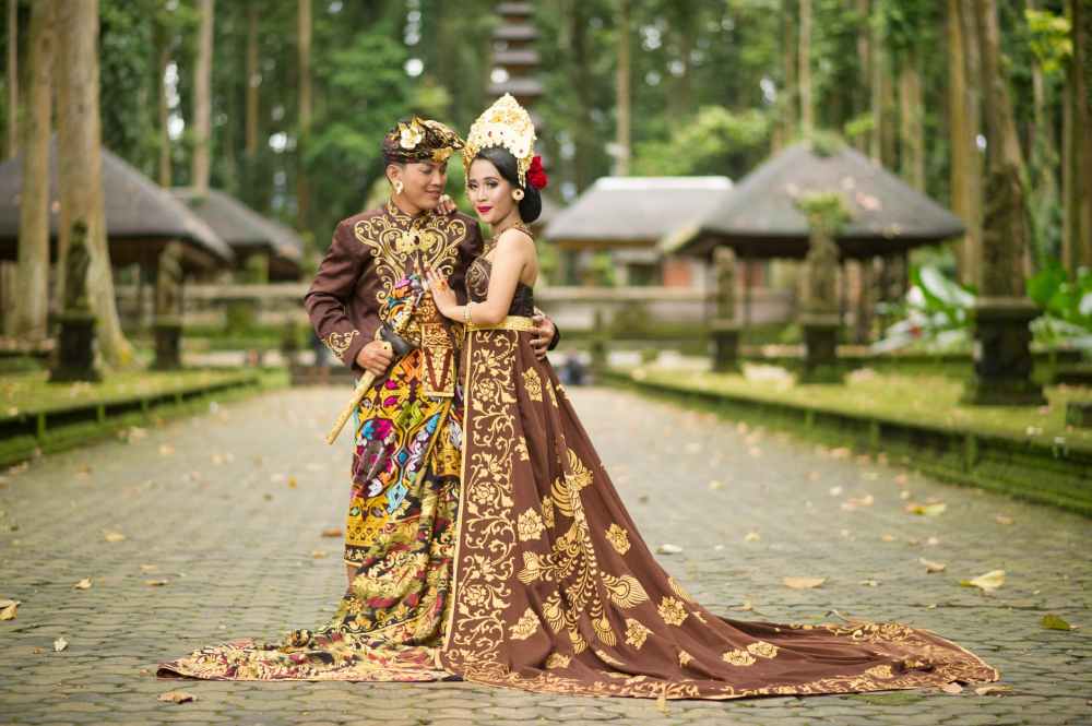 photo of man and woman wearing brown floral dress