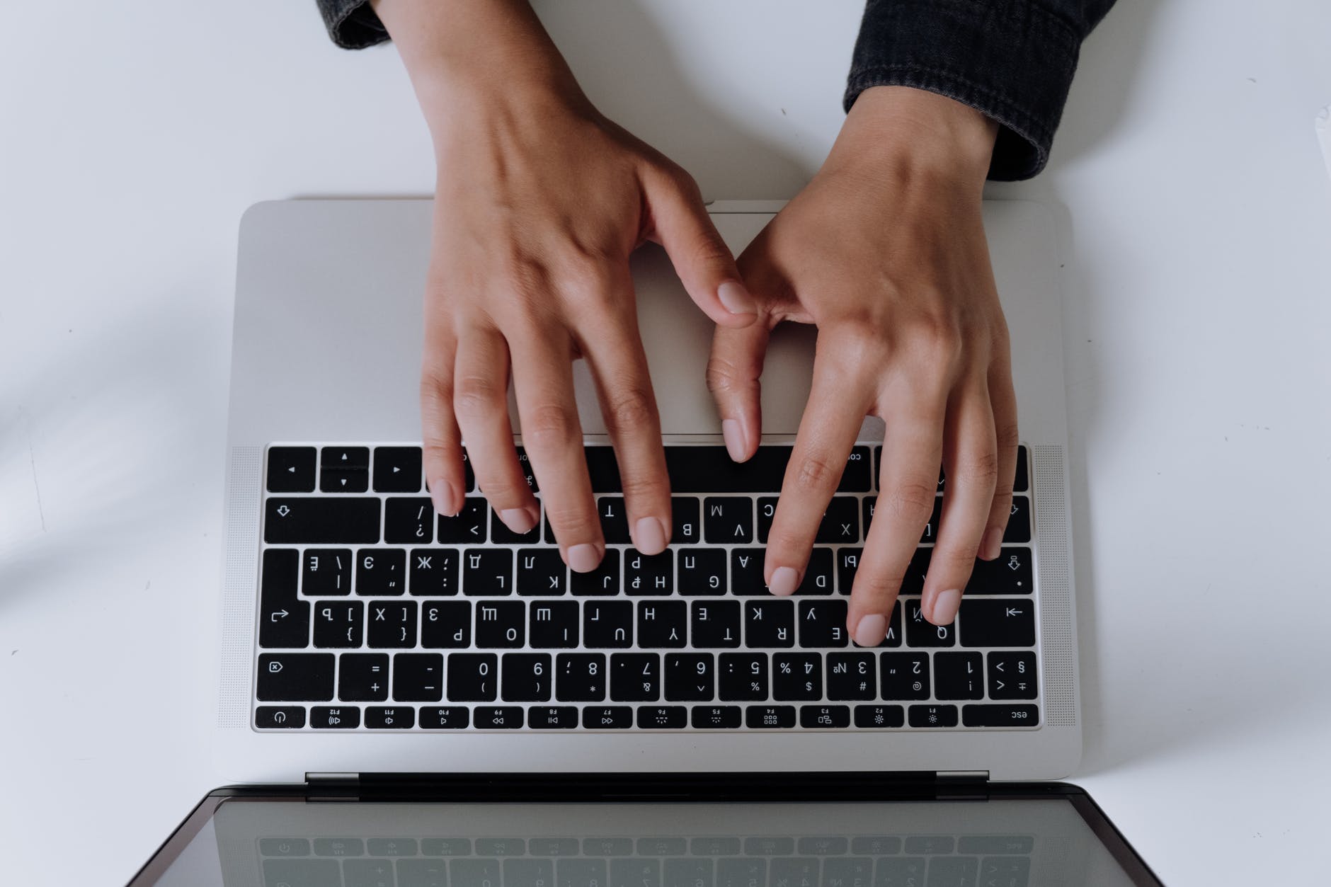 persons hand on silver and black laptop computer