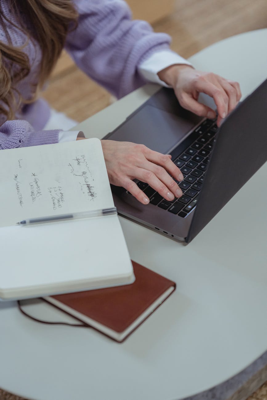 crop woman typing on laptop